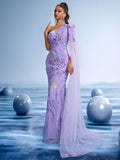 Elegant lavender one-shoulder mermaid evening gown with 3D floral crystal beading and a long sheer flowing cape train for gala or wedding guests.
