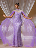 Stunning royal amethyst purple mermaid evening gown featuring intricate crystal embroidery, an illusion high neck, and long flowing sheer tulle cape sleeves for formal galas.