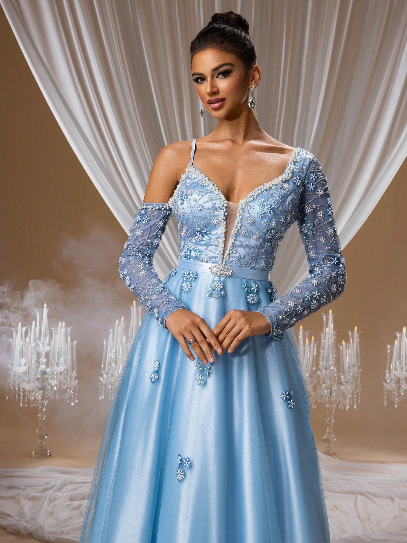 Sapphire blue floral beaded ball gown featuring a sheer V-neckline, intricate crystal-embellished long sleeves, and a shimmering floor-length skirt for formal galas or luxury weddings.