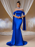 Elegant woman wearing a glamorous royal blue satin evening gown featuring a sheer high-neck cape with intricate silver beading, a sleek floor-length ball gown silhouette with a subtle slit, perfect for red carpet and grand gala events.