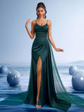 Elegant emerald green mermaid evening gown with thin spaghetti straps, a sparkling sequin-embellished waistband, and a dramatic high thigh slit for beach weddings or galas