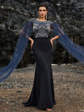 Glamorous navy blue mermaid evening gown featuring silver crystal-embroidered bodice, elegant sheer tulle cape sleeves, and a high slit for formal galas or red carpets.