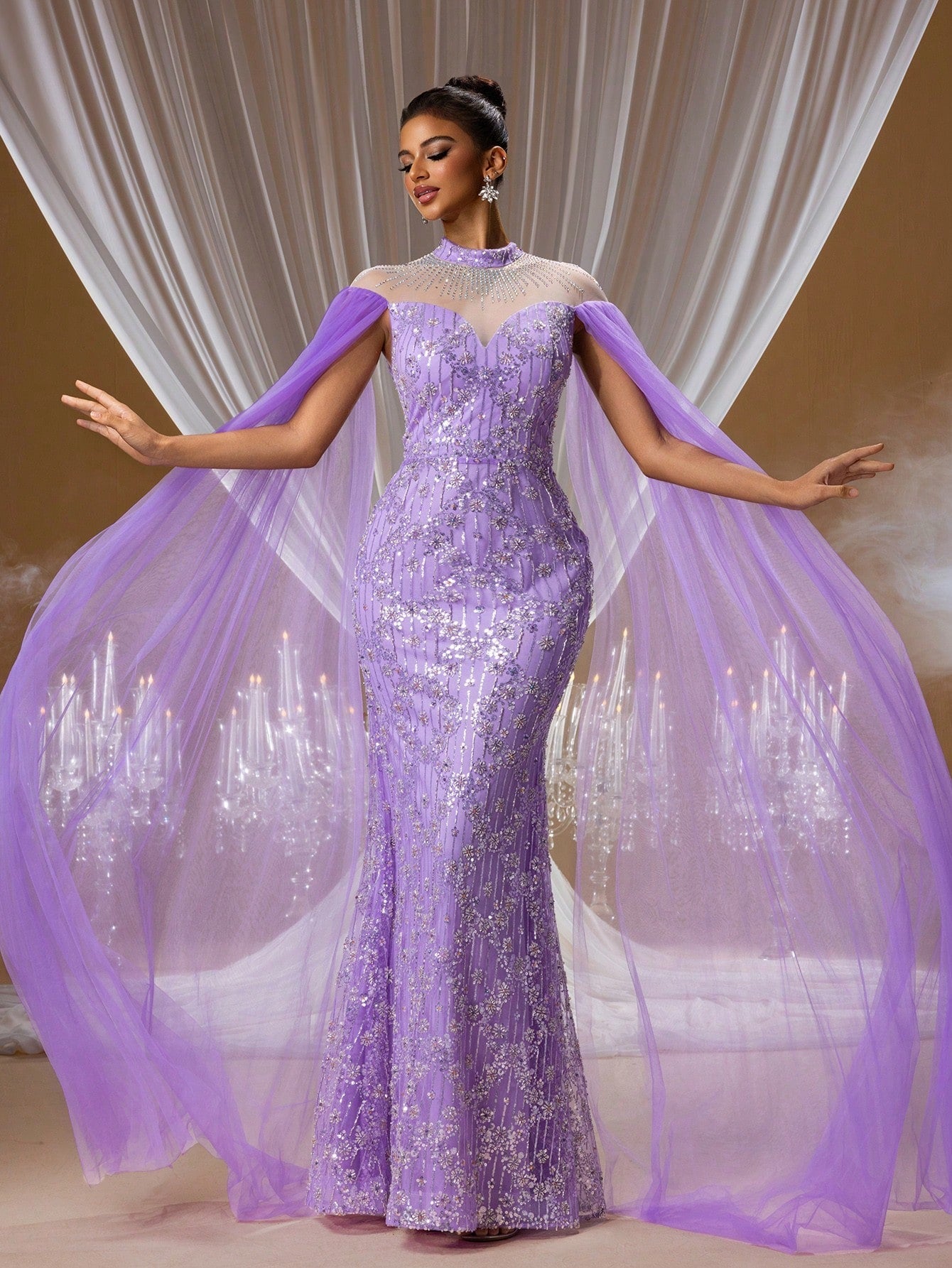 Stunning royal amethyst purple mermaid evening gown featuring intricate crystal embroidery, an illusion high neck, and long flowing sheer tulle cape sleeves for formal galas.