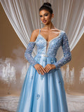 Sapphire blue floral beaded ball gown featuring a sheer V-neckline, intricate crystal-embellished long sleeves, and a shimmering floor-length skirt for formal galas or luxury weddings.