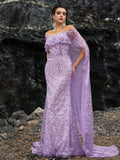 Starry lavender off-shoulder mermaid evening gown featuring a crystal-accented sheer cape, intricate purple sequin embroidery, and a sparkling floor-length silhouette for weddings or red carpets.