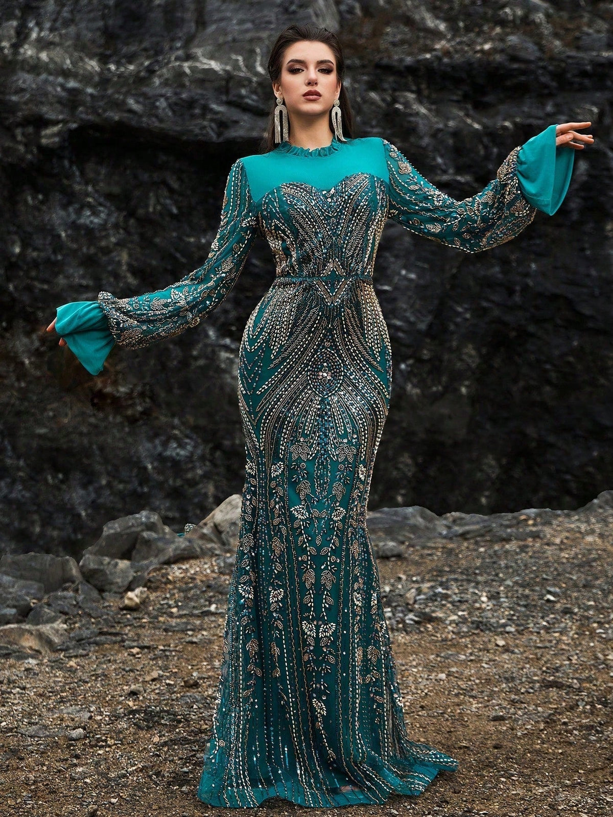 Teal and gold sequin mermaid evening gown featuring dramatic bell sleeves, intricate floral embroidery, and a sheer high neck for formal galas or weddings.