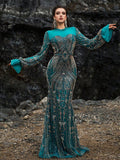 Teal and gold sequin mermaid evening gown featuring dramatic bell sleeves, intricate floral embroidery, and a sheer high neck for formal galas or weddings.
