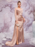 Elegant woman in a Romantic Soft Pink Satin Evening Gown featuring sheer beaded long sleeves, a ruched bodice, and a high side slit, perfect for galas and formal luxury events.
