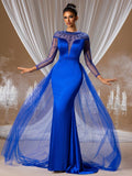 Stunning Royal Blue Evening Gown featuring an illusion beaded neckline, sheer long sleeves, and a dramatic floor-length tulle overskirt, ideal for weddings and gala events.